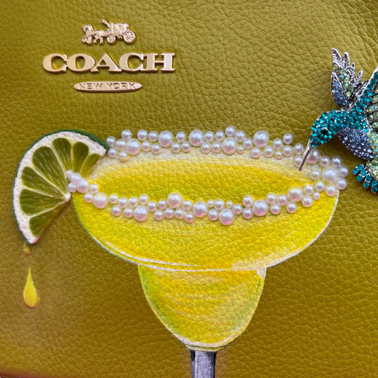 purse painted with margarita, pearly salt and a hummingbird drinking from the glass