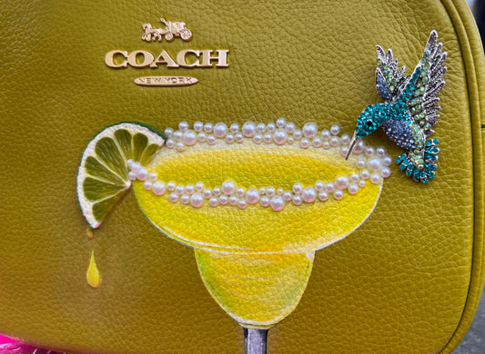 purse painted with margarita, pearly salt and a hummingbird drinking from the glass